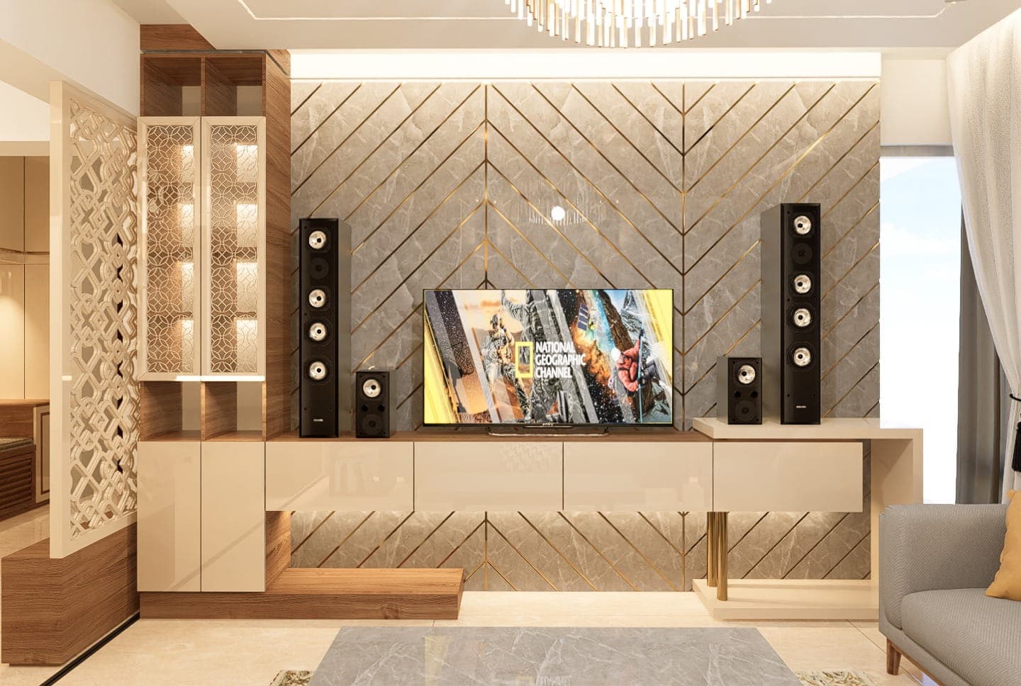 A media wall for a luxury interior: a chevron-panelled feature wall in stone and brass frames a mounted television between tower speakers.